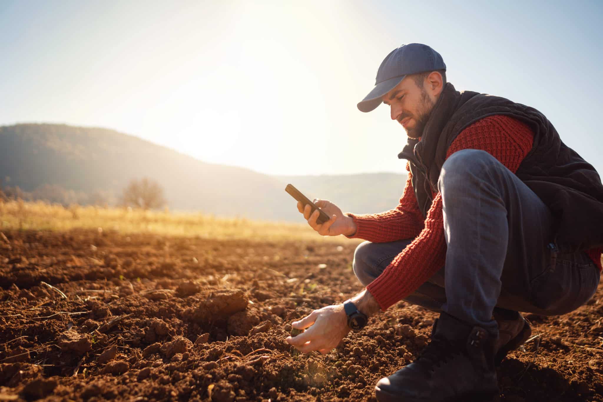 Farmer using his mobile phone while working in the field
